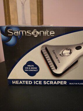 Heated ice scraper